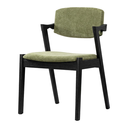 A modern dining chair with a black wood frame and light olive green textured fabric upholstery on the seat and curved backrest, shown against a plain white background.