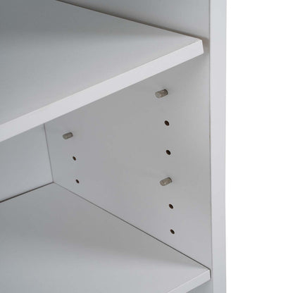 Close-up of a white adjustable shelving unit showing the back panel with pre-drilled holes and metal mounting pegs.