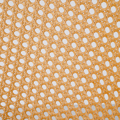 A close-up of a woven cane or rattan panel with a repeating geometric pattern of interlaced light tan strips and circular cutouts.