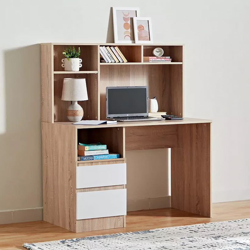 A light oak wood hutch desk with a matching hutch shelf, featuring three white drawer fronts on the lower left, open shelving, a desk surface with a laptop, and decorative items, set against a neutral beige wall.