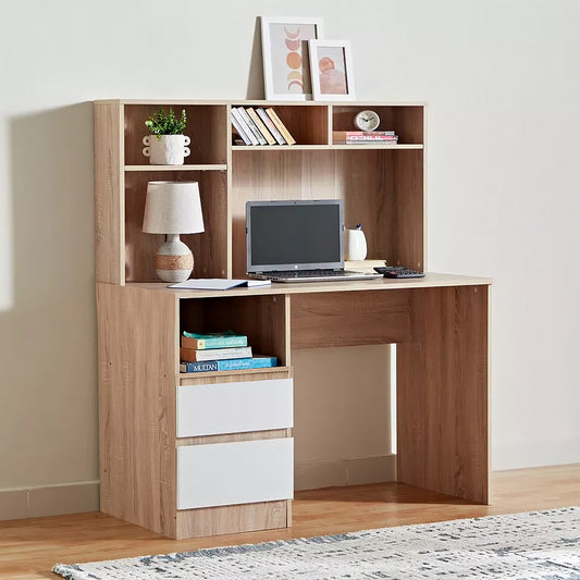 A light oak wood hutch desk with a matching hutch shelf, featuring three white drawer fronts on the lower left, open shelving, a desk surface with a laptop, and decorative items, set against a neutral beige wall.