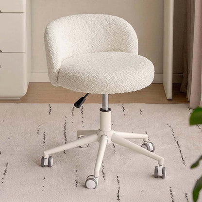 A cream-colored, sheepskin-textured rolling office chair with a five-star base and casters, set on a light patterned rug in a home office environment.