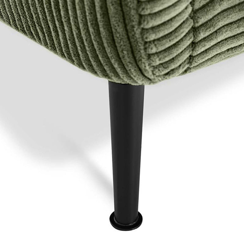 Close-up of the corner of an upholstered armchair with ribbed sage green fabric and a black metal leg on a white background.