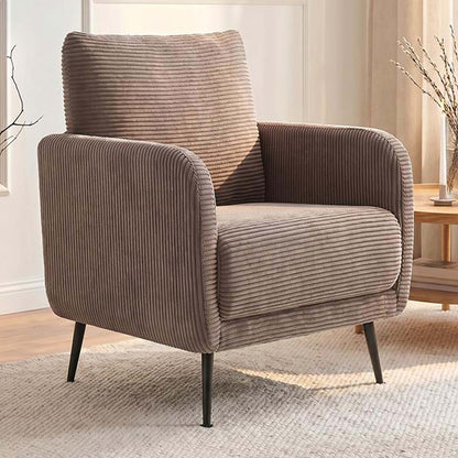 A modern corduroy armchair in a warm taupe-brown color, styled in a bright living room setting with a matching back cushion, dark metal legs, and a textured rug.