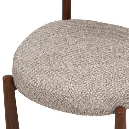 Close-up of a round upholstered chair seat in a textured beige and white woven fabric, with dark brown wooden legs visible against a white background.